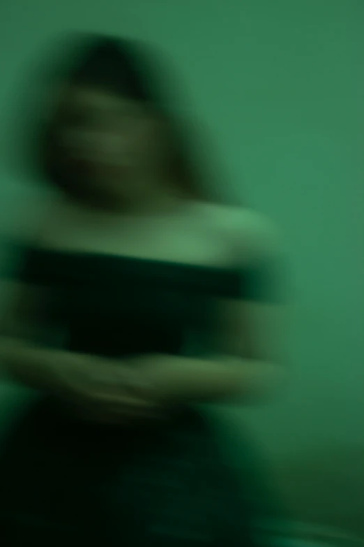 blurry pograph of an asian woman in a black dress