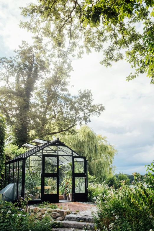 a house in a garden with steps going up and an out door gazebo