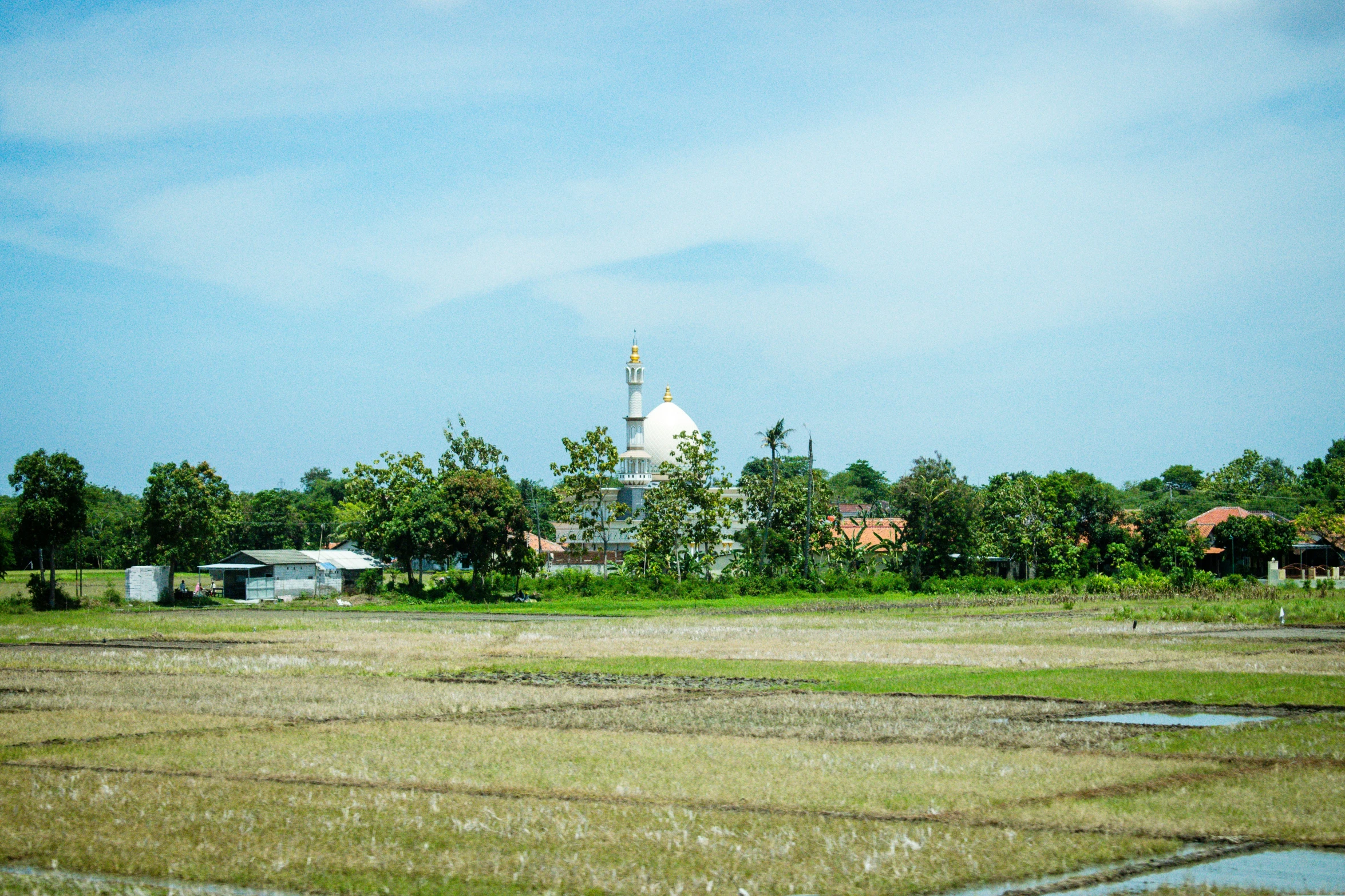 a white church on an empty field in the middle of nowhere