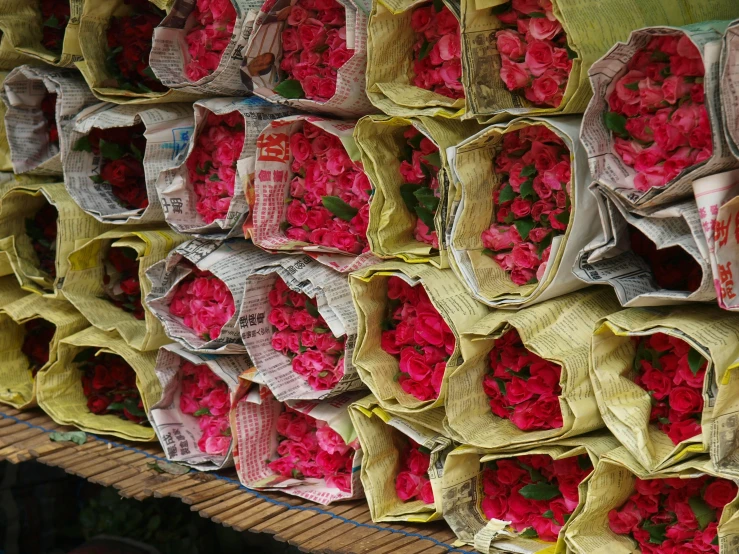 a large stack of newspapers wrapped with flowers