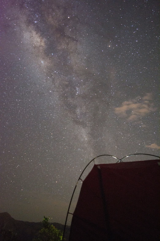 a sky with a lot of stars that have a tent on top