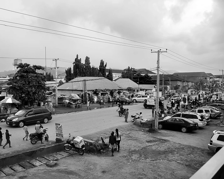 a busy street with cars, trucks and people walking on the side