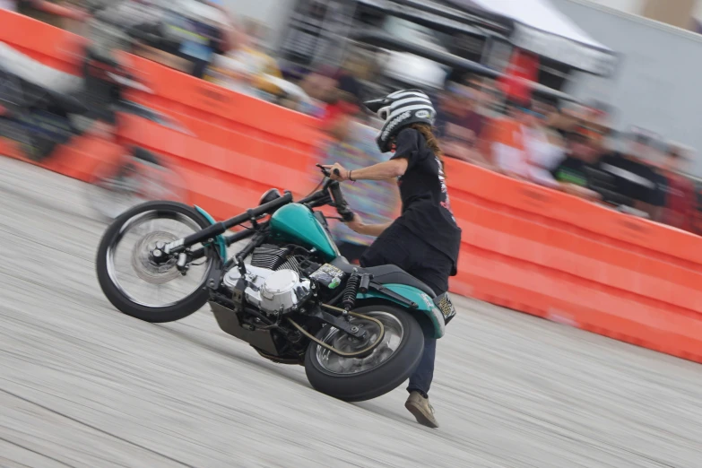 person on a motorcycle performing an aerial stunt