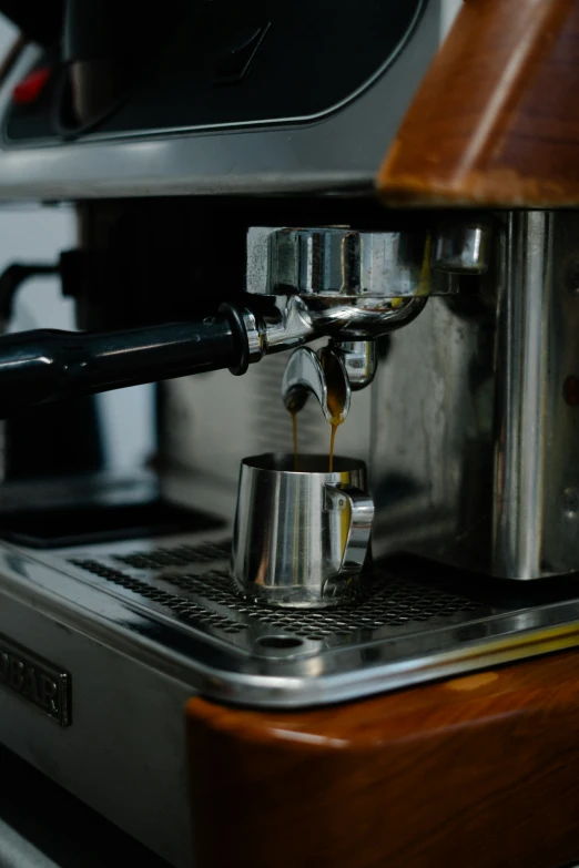 an espresso machine with the handle extended pouring espresso coffee into the cup