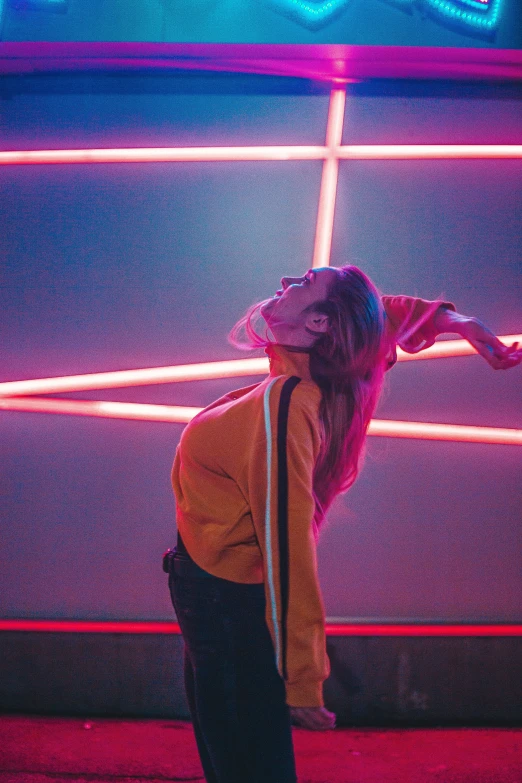 a woman using an umbrella in a neon lit room