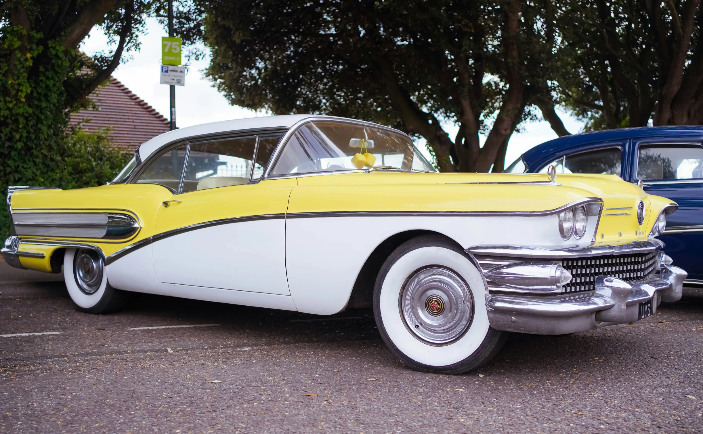 an old car sits in a parking space