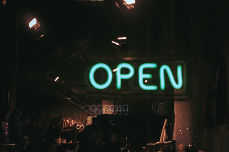 the open sign is lit up in the dark