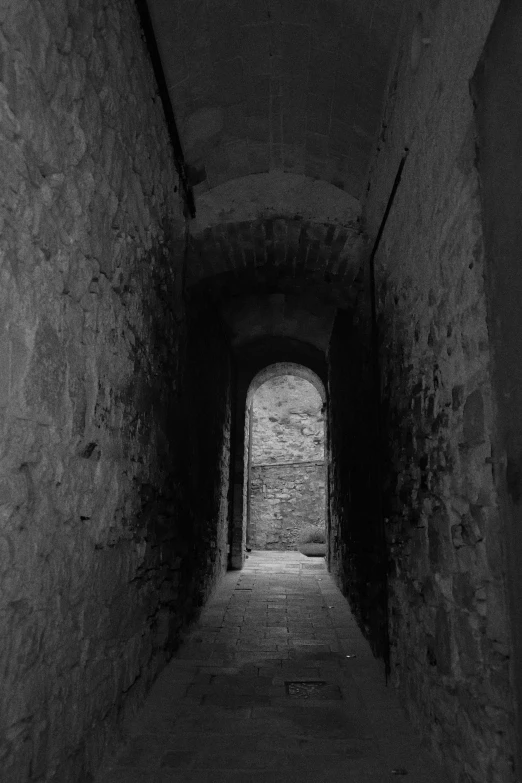 dark alley with light from the end and small tunnel for entering