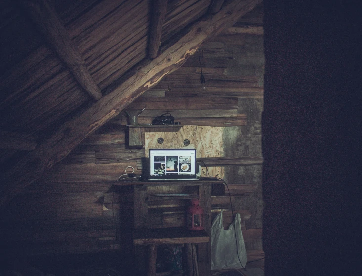 a small computer is on a table by the window