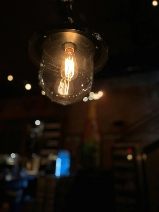 a light hanging from the ceiling inside a restaurant