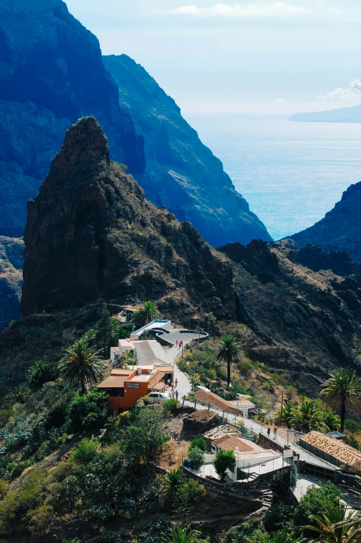 a landscape view of the mountains with a house