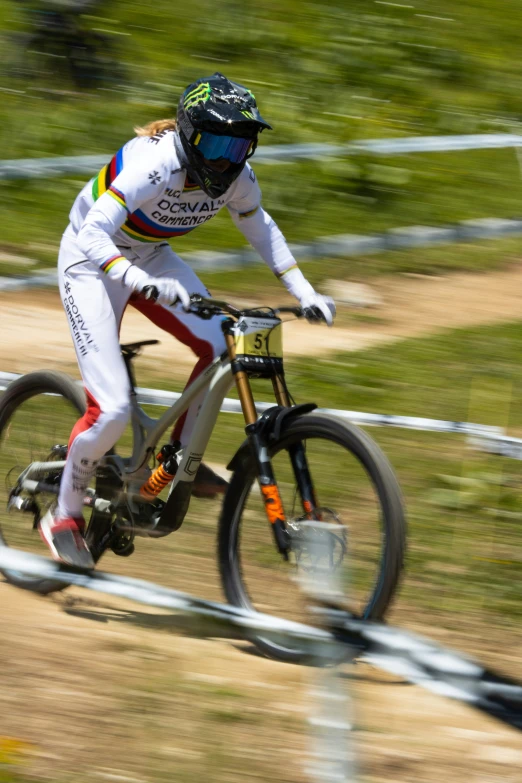 a person riding a bike down a dirt course