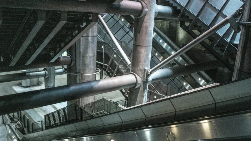 several pipes in a building, suspended from the ceiling