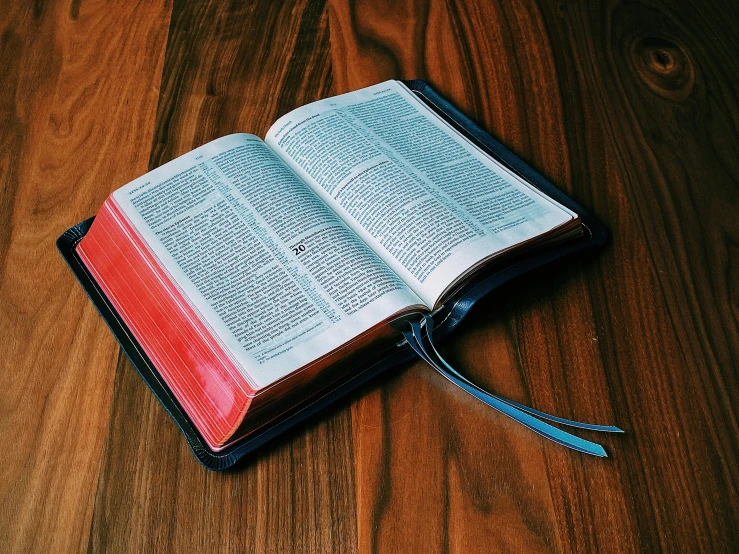 an open bible laying on the floor