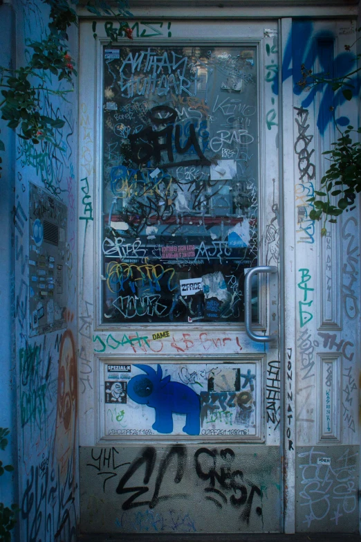 a door with grafitti on it and a metal latch