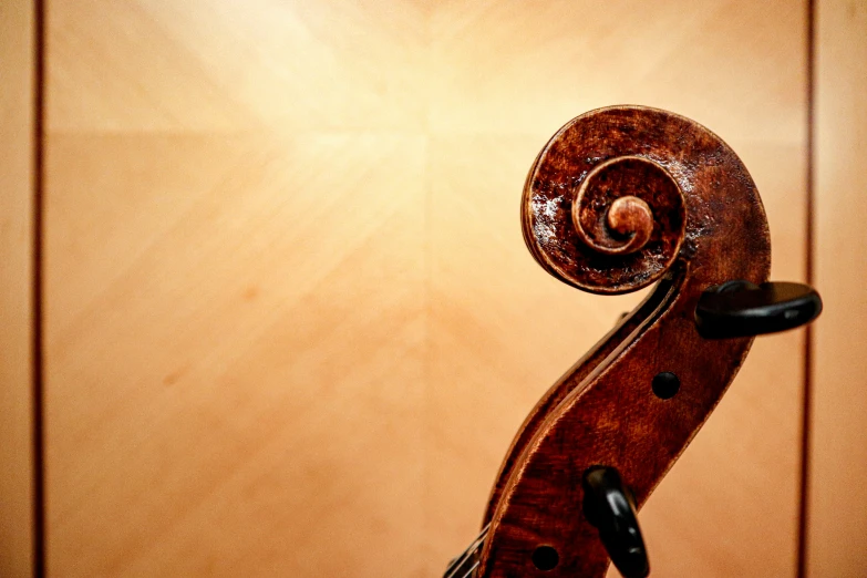 an old violin that is propped against a wall