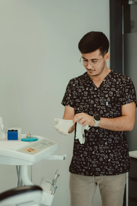 man standing in the corner using his hands with gloves on