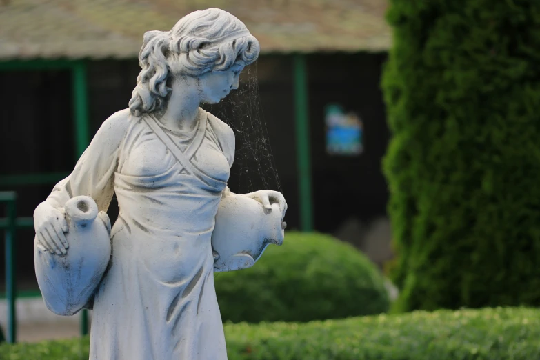 a white statue of a woman holding a baby