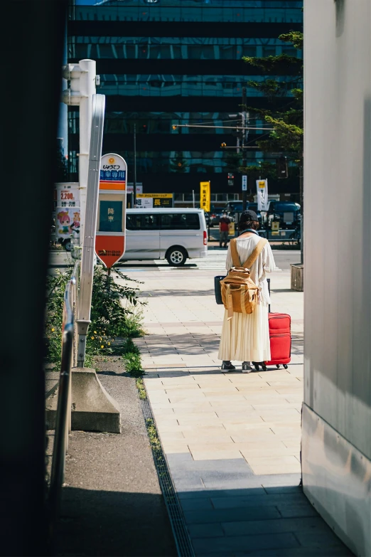 a man who is standing by some red luggage