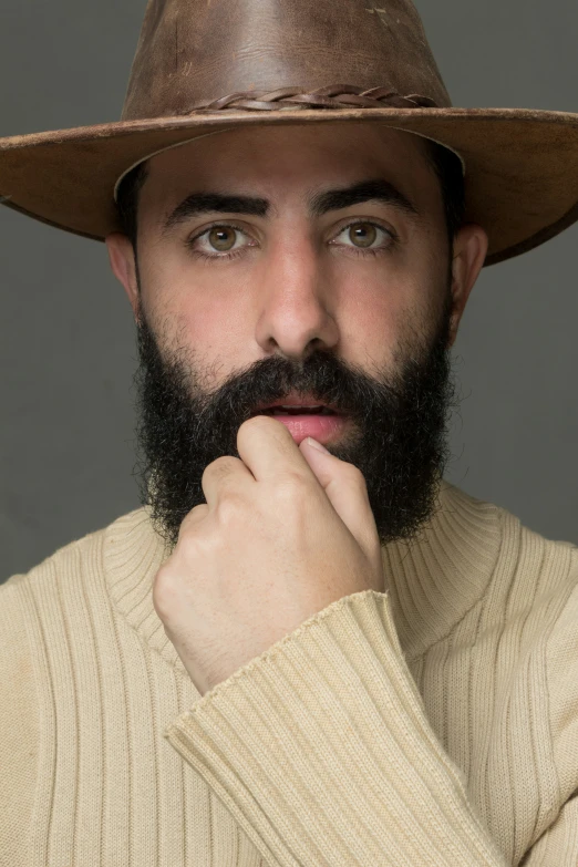 a man in a hat is looking to the side