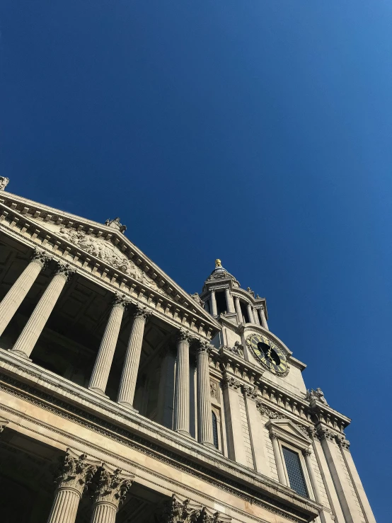 the top part of an architectural building with stone pillars