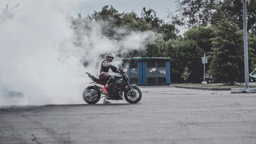 a person riding a red motorcycle in the street