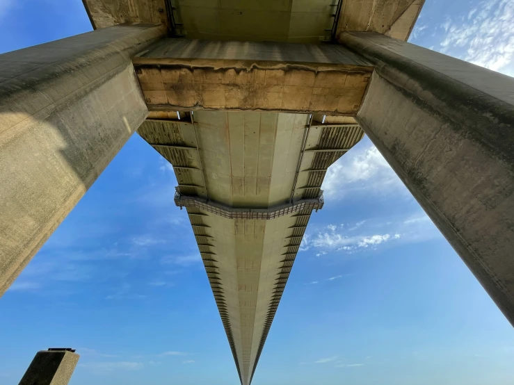 a picture looking up at the underside of an old concrete structure