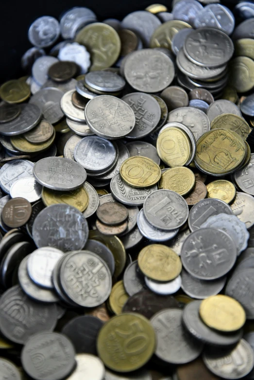 silver and gold colored coins of various countries