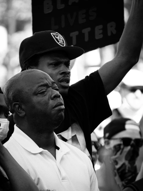 a group of men standing next to each other holding signs