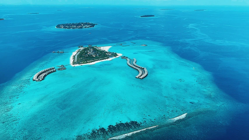 an island with many white sanded structures on it is surrounded by blue water
