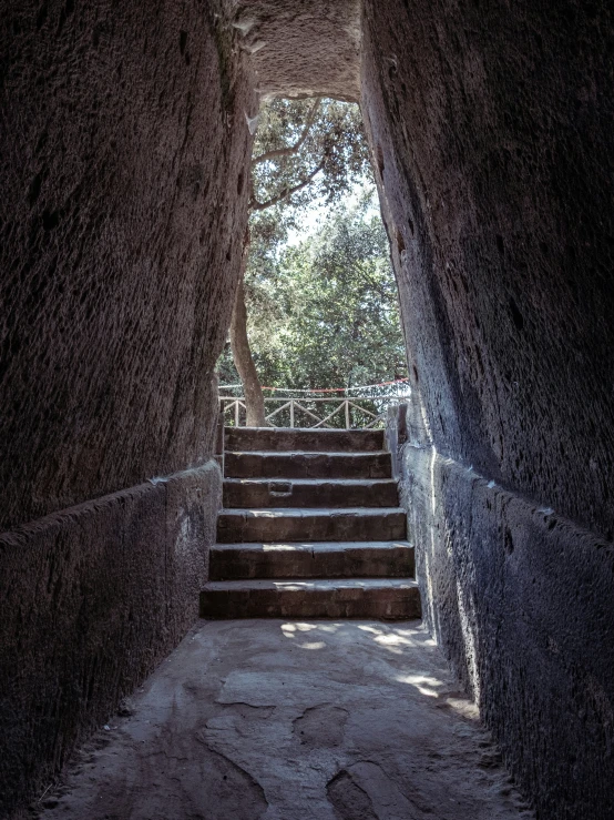 a set of stairs in a dark stone tunnel