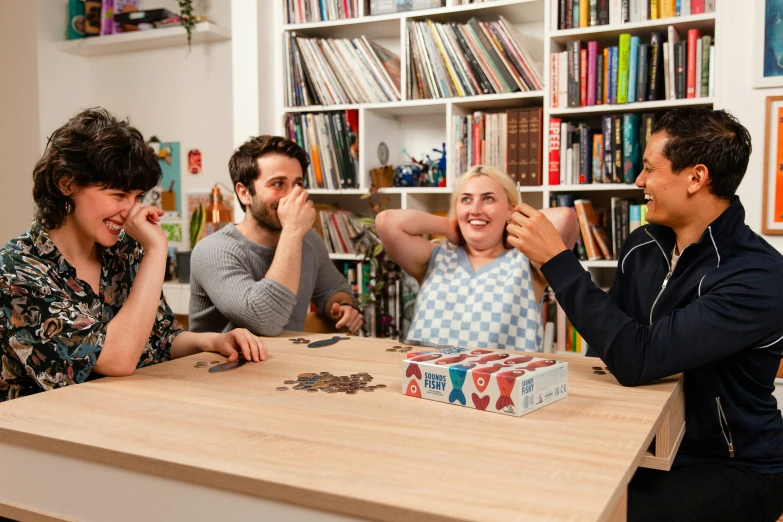 two women and a man playing games at the table