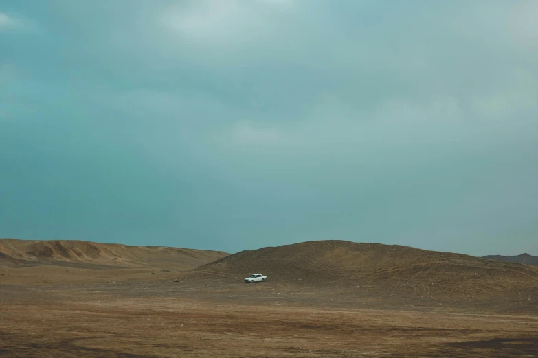 an airplane is flying over a hill with rocks