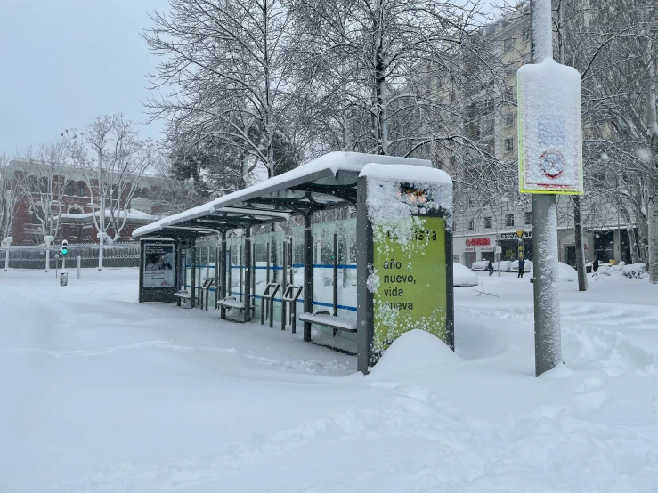 an open bus stop on a snowy day