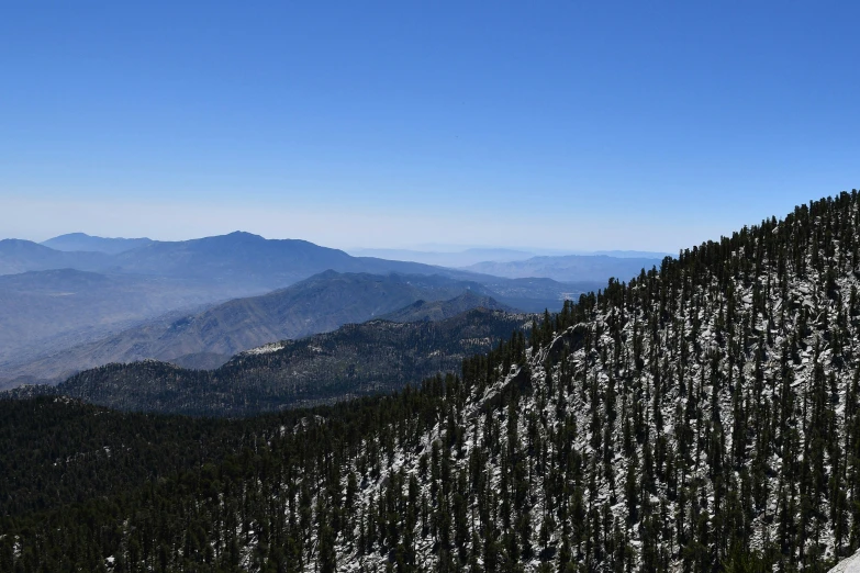 the view from the top of a mountain of a snowy slope