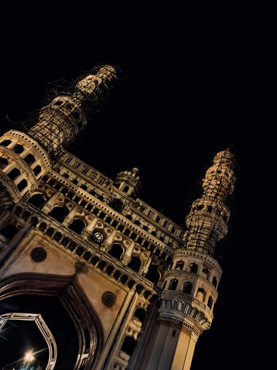 a very tall clock tower towering over a city at night