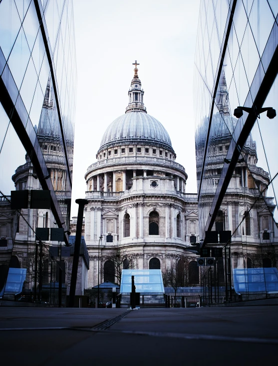 the st paul's cathedral as seen through some glass buildings