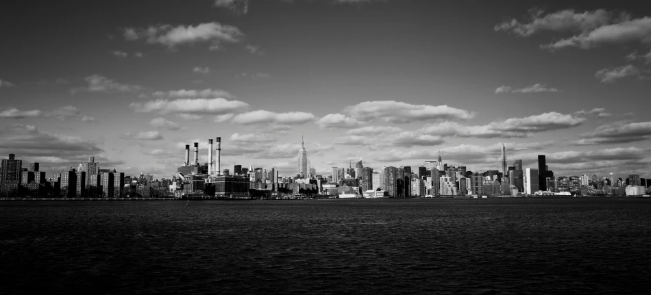 black and white pograph of skyline with water below