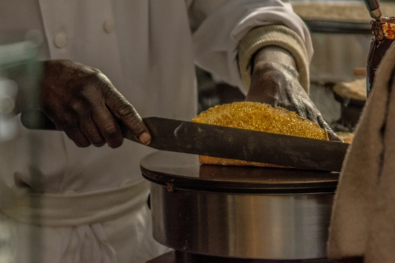 a person placing soing into an iron in an open pot