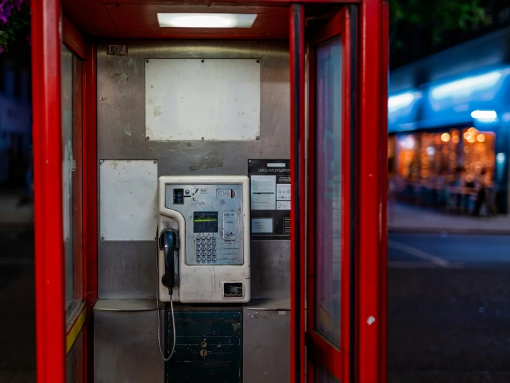 a large red box sitting next to a parking meter