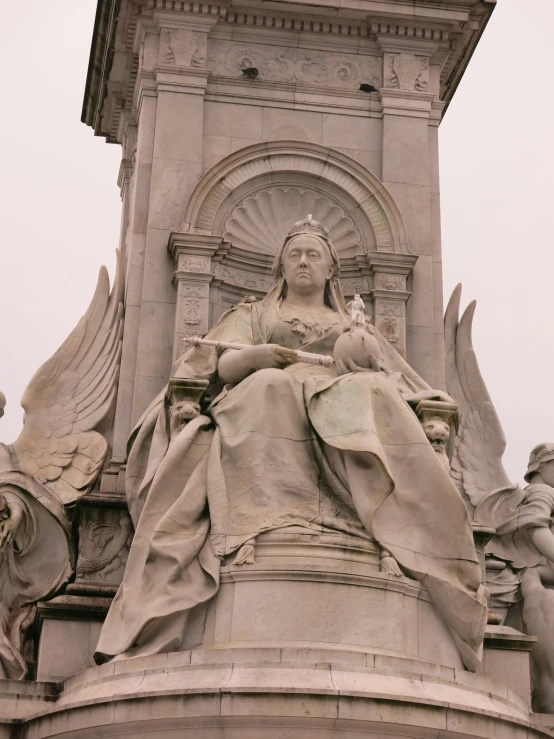 a sculpture that is made of cement with a clock on it