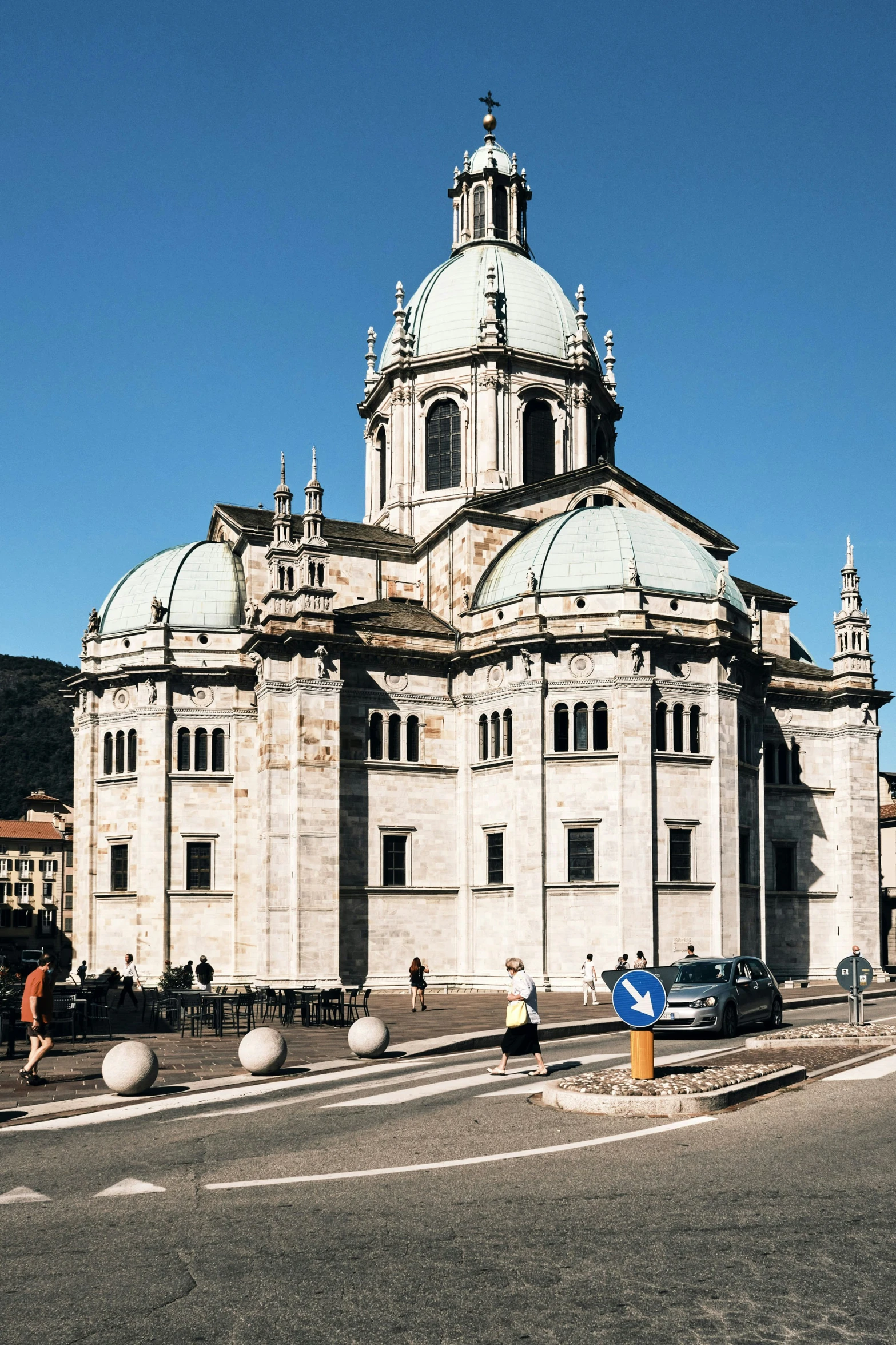 an old building with many towers and cars parked on the street