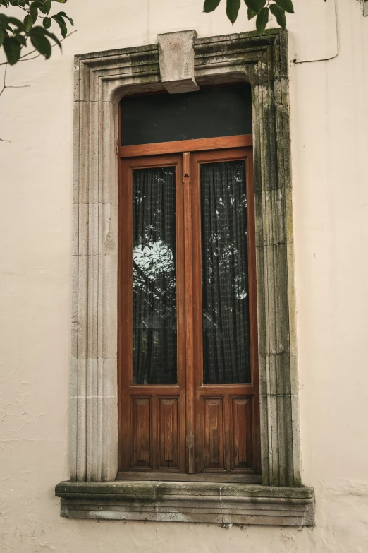 a wood door and window on a white building