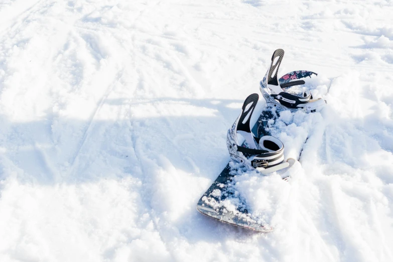 a snowboard is propped up in the snow