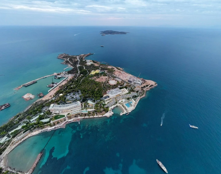 an island sitting in the middle of blue water