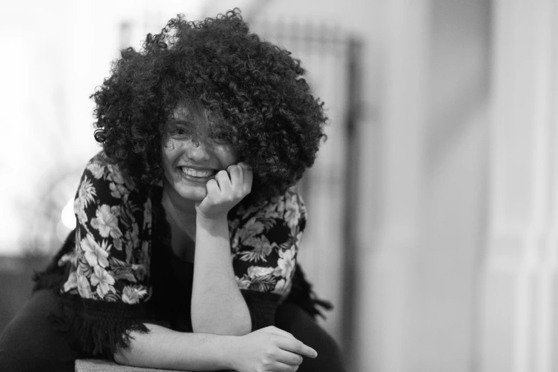 a woman sitting with her hand on her head