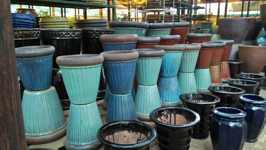 several colors of ceramic vases stacked against one another