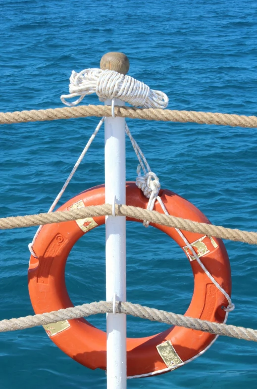 an orange life buoy on the front of a boat