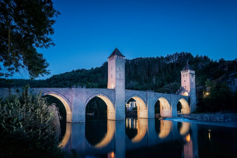 an old stone bridge sitting next to water