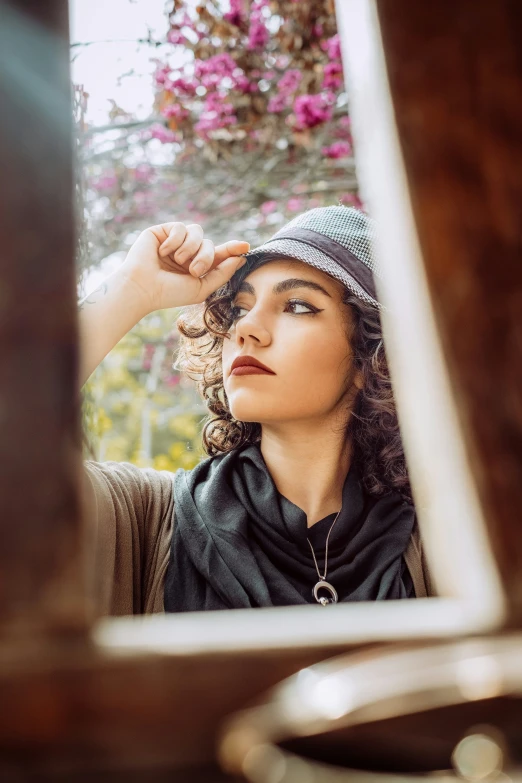 a woman is looking at herself in the mirror